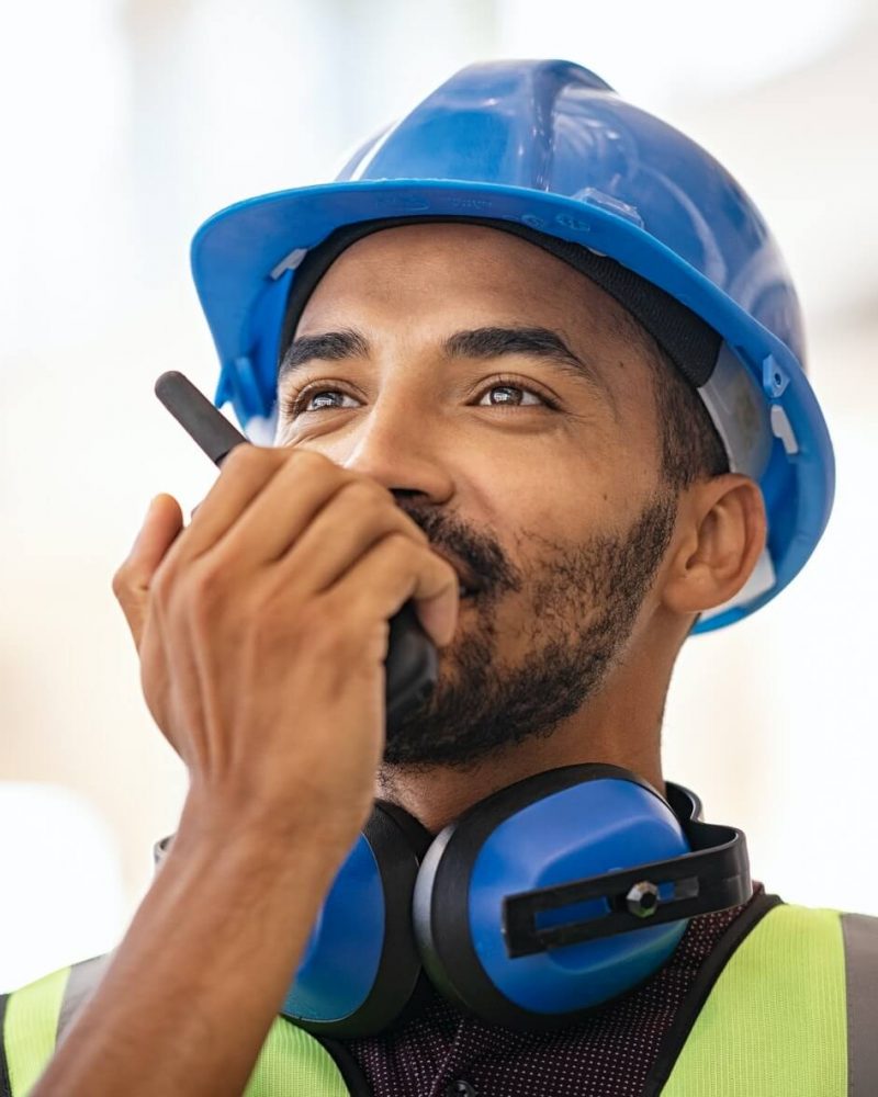 mixed-race-construction-worker-using-walkie-on-construction-site-1.jpg